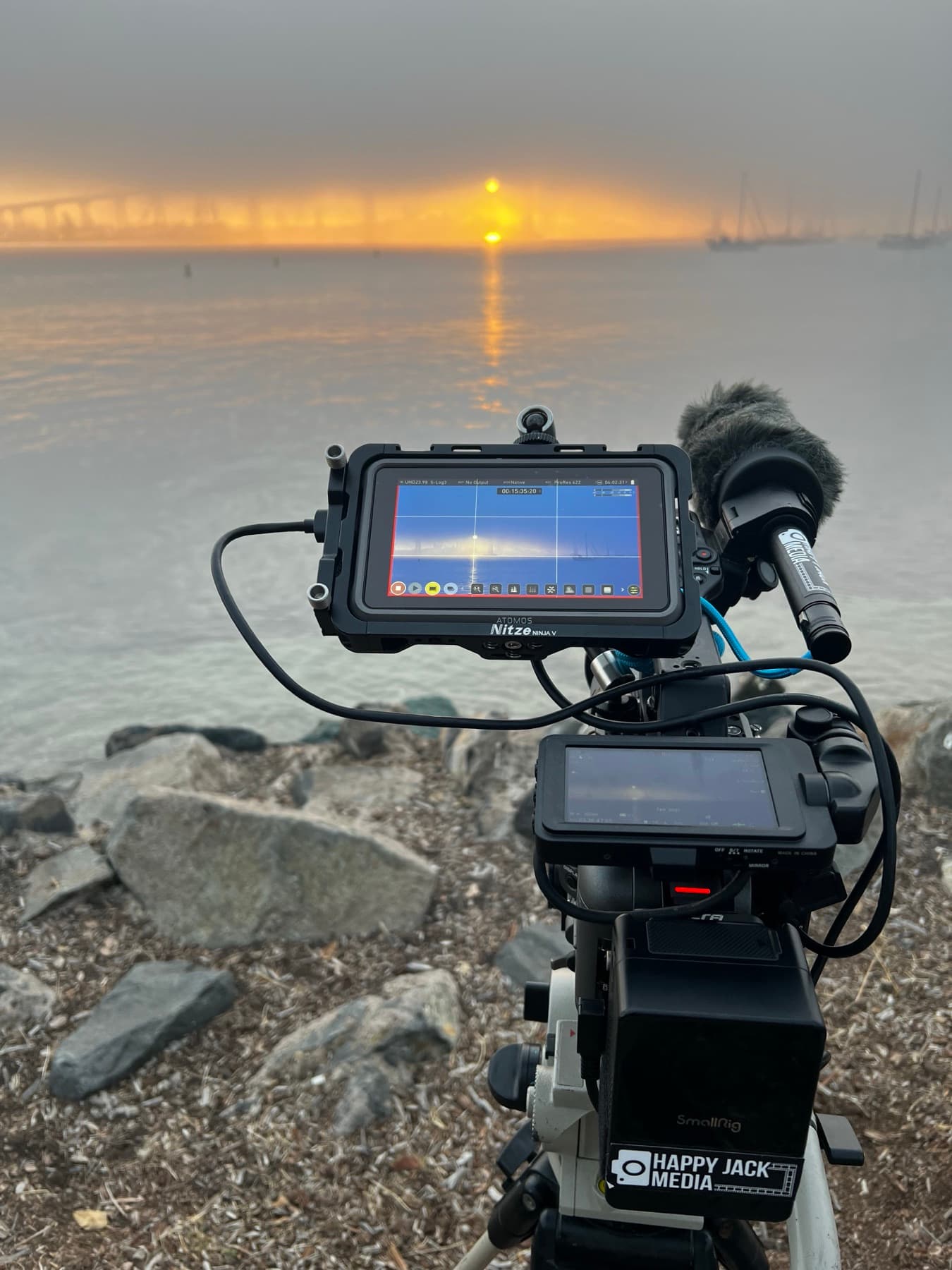 A Happy Jack Media documentary camera filming the sun over the water